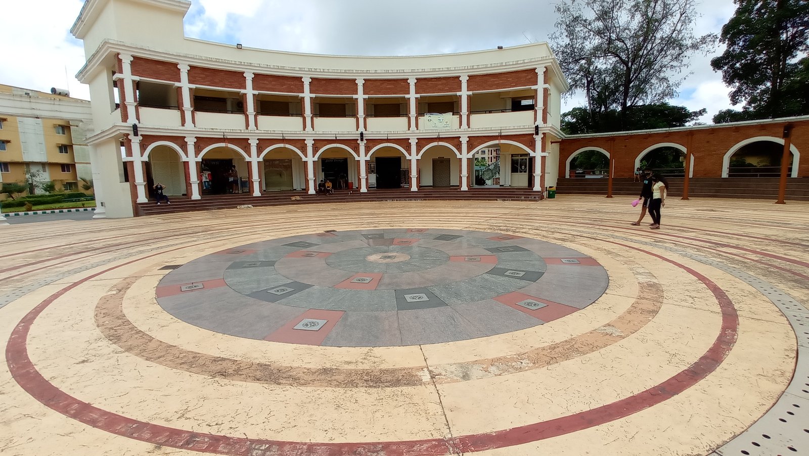 The circular Student Plaza and arched brick buildings at MIT Manipal